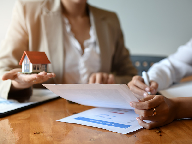 real estate appraiser filling out paperwork with client buda tx